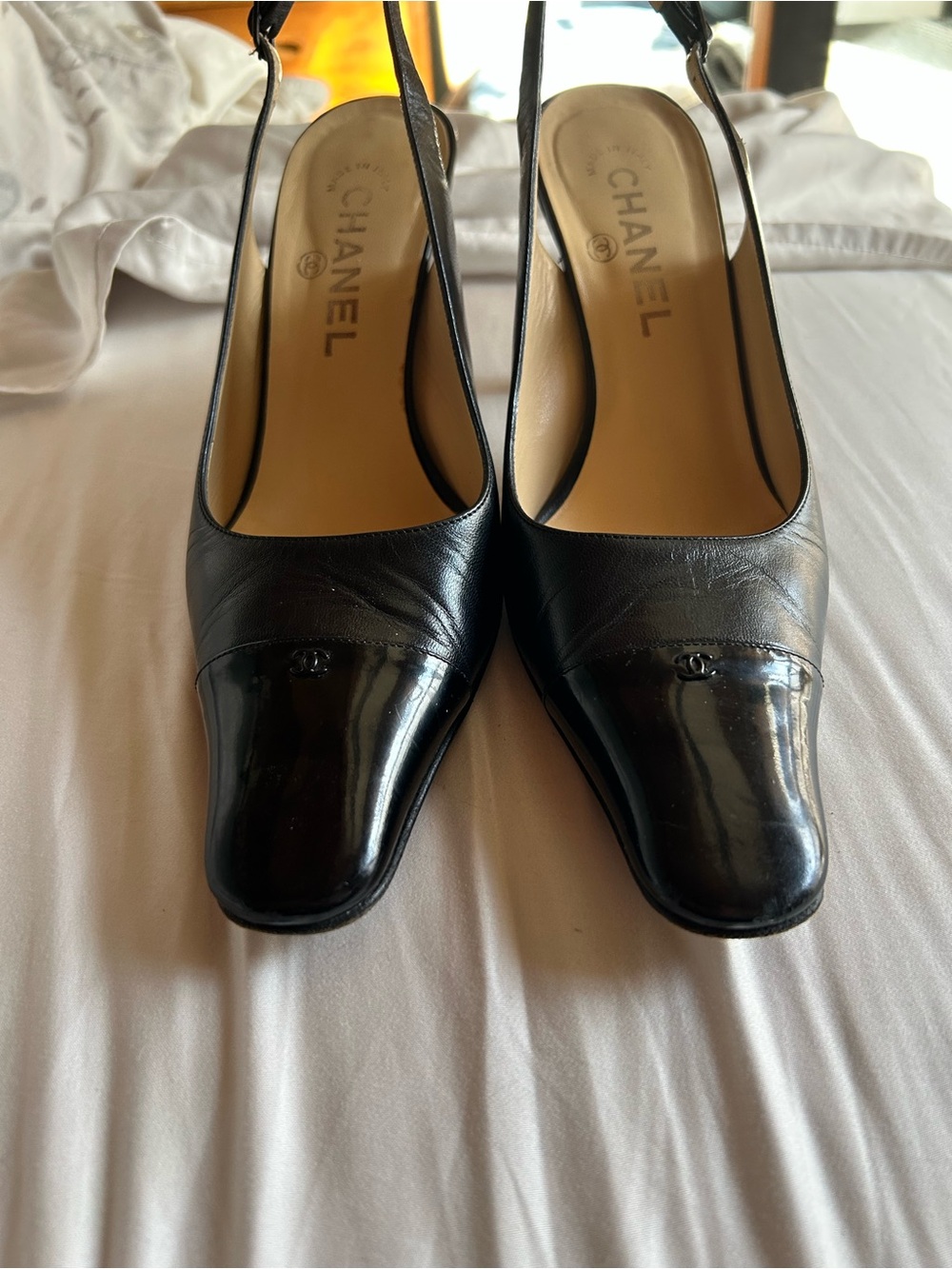 CHANEL Black Leather Slingback Pumps with Patent Cap Toe and Logo